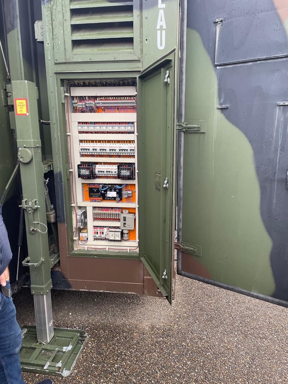 Open exterior electrical cabinet showing wiring, breakers and control components