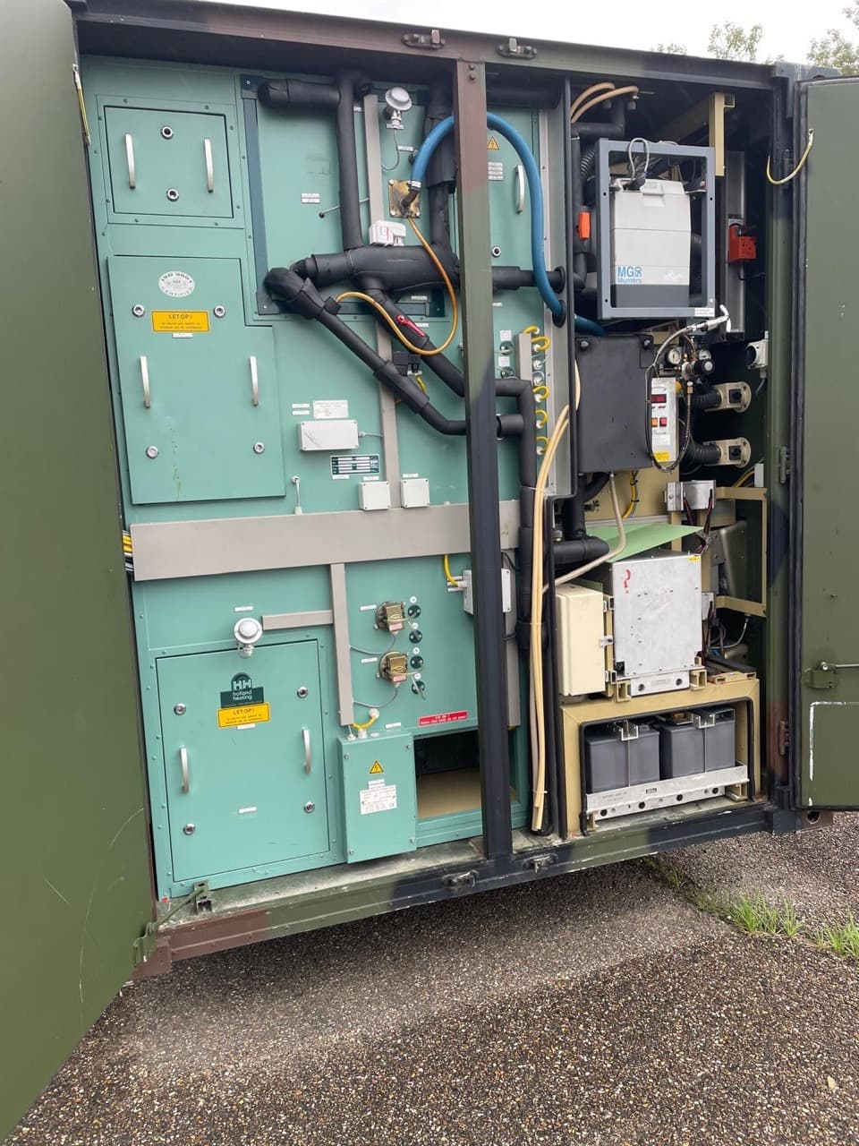 Open external service bay with insulated pipework and air-handling equipment