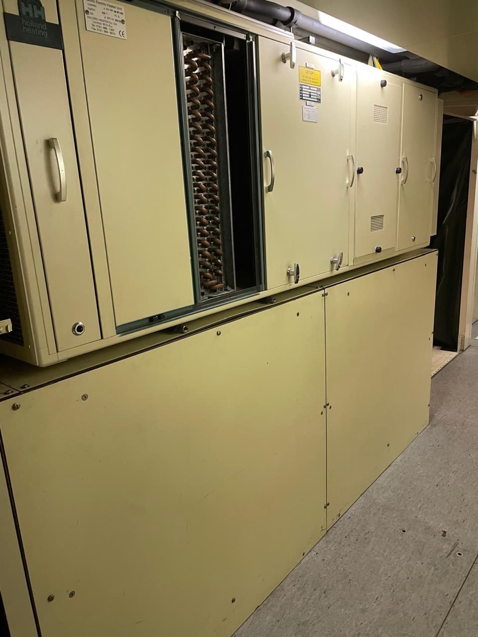 Interior heating cabinet with an open panel revealing a coil