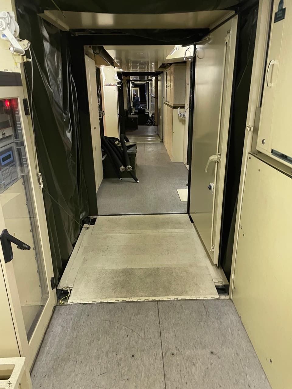 Interior corridor passing through the connected hospital modules, with doors and flexible connections