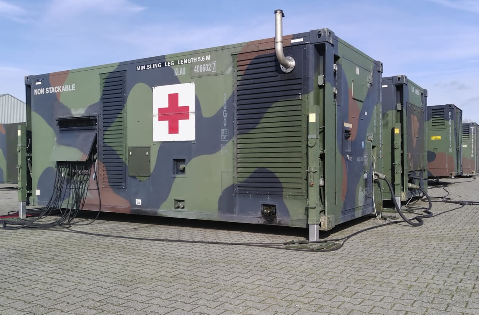Field hospital module marked with a red cross, part of a complete containerized hospital