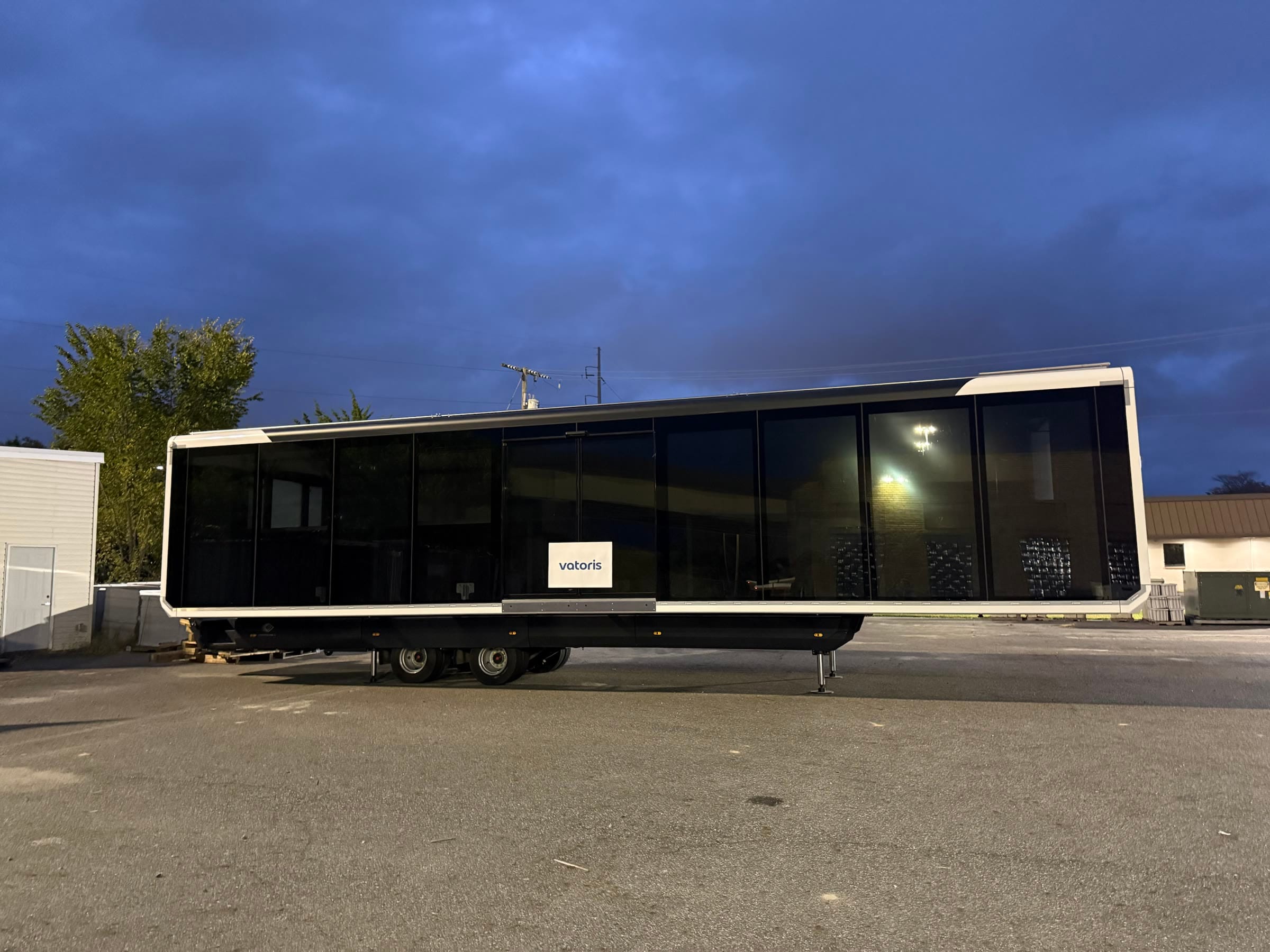 The expandable unit side-on at dusk, standing on its support legs