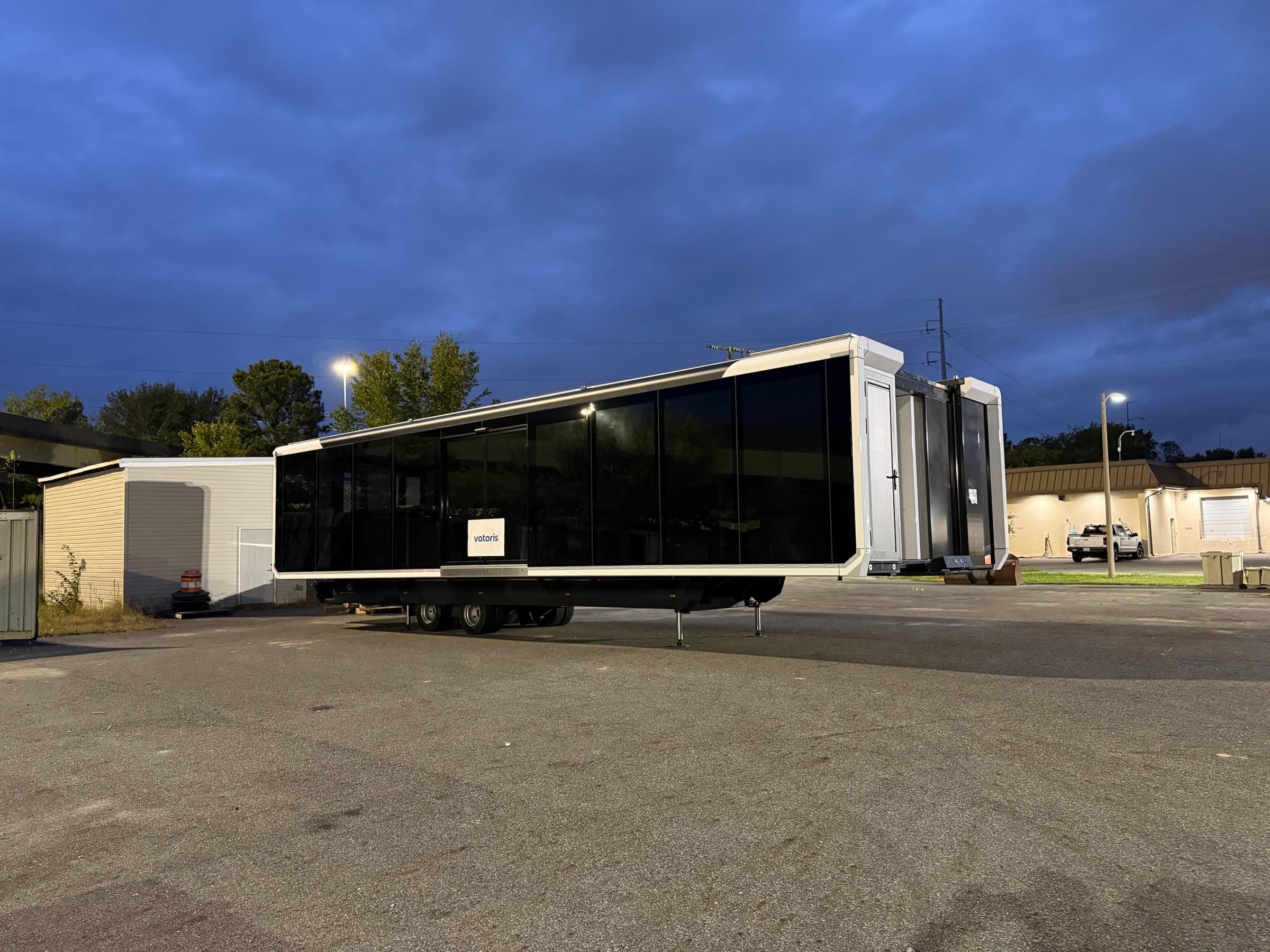 Three-quarter view of the expandable unit at dusk, with its end section open