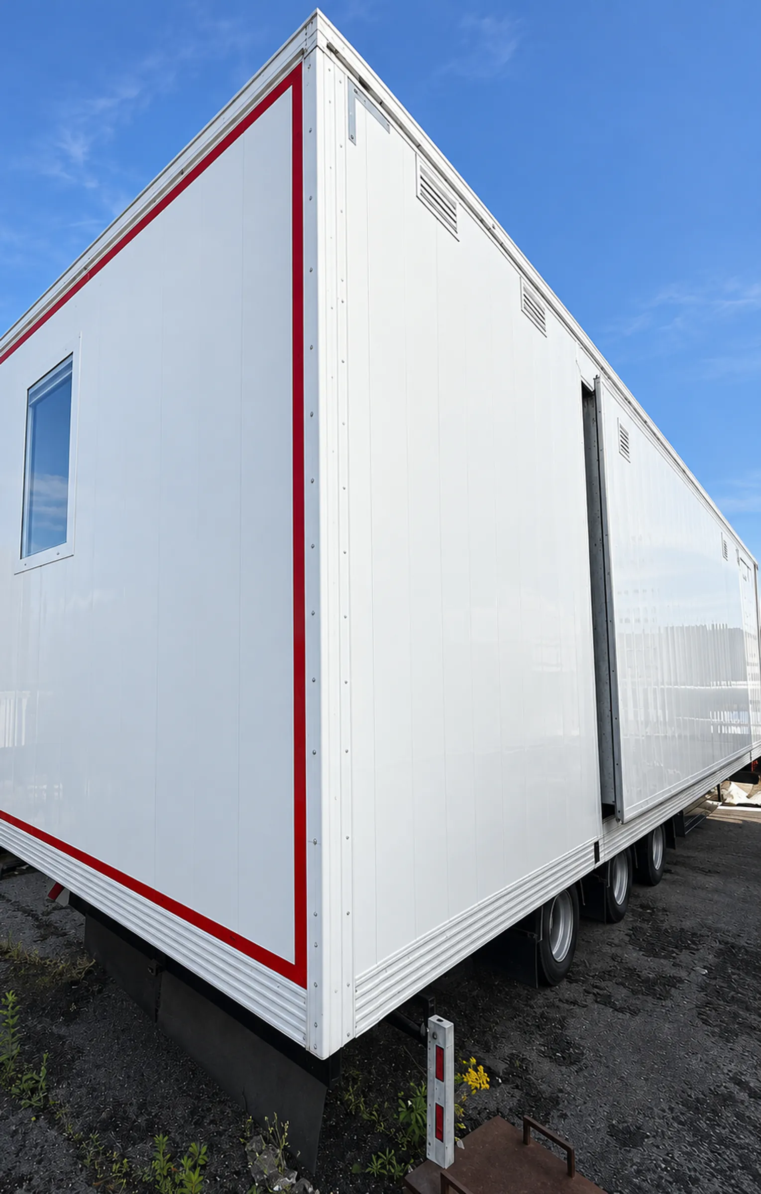 Corner of a Quad outpatient trailer showing a consultation-room window